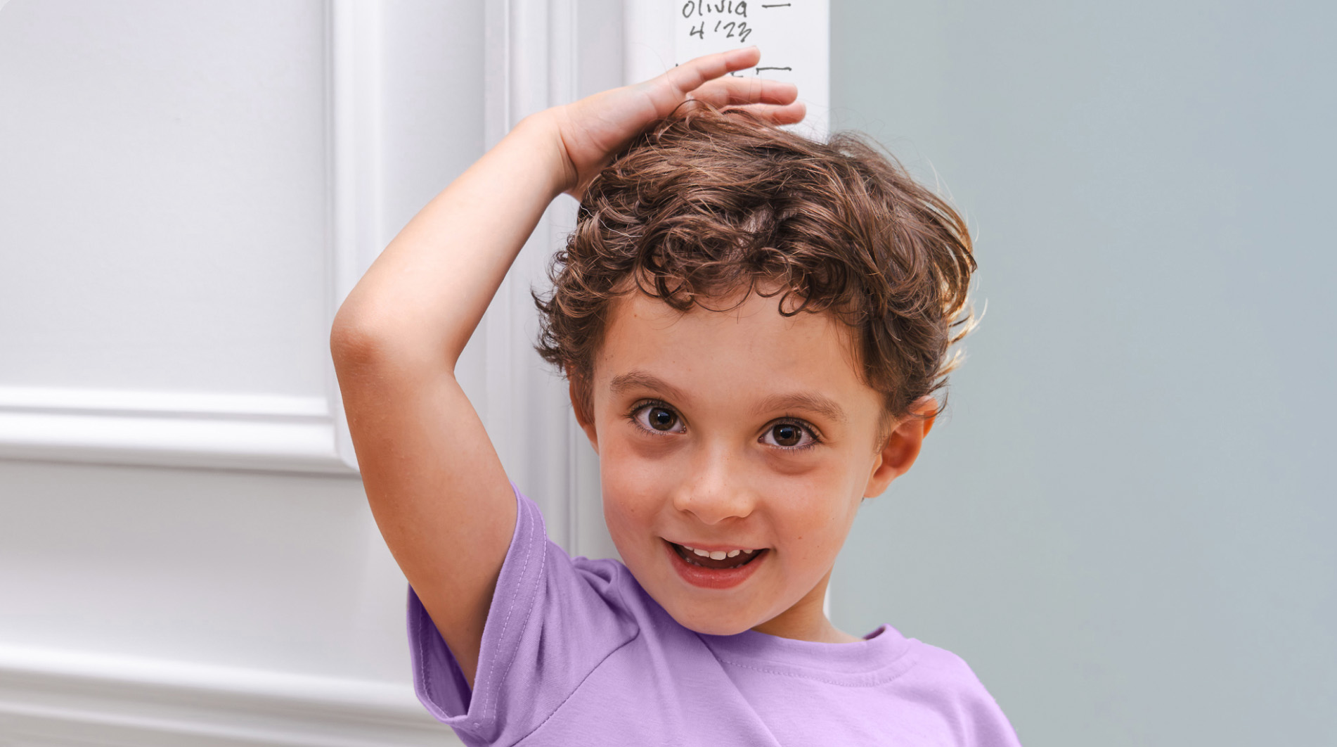 Image of boy measuring his height