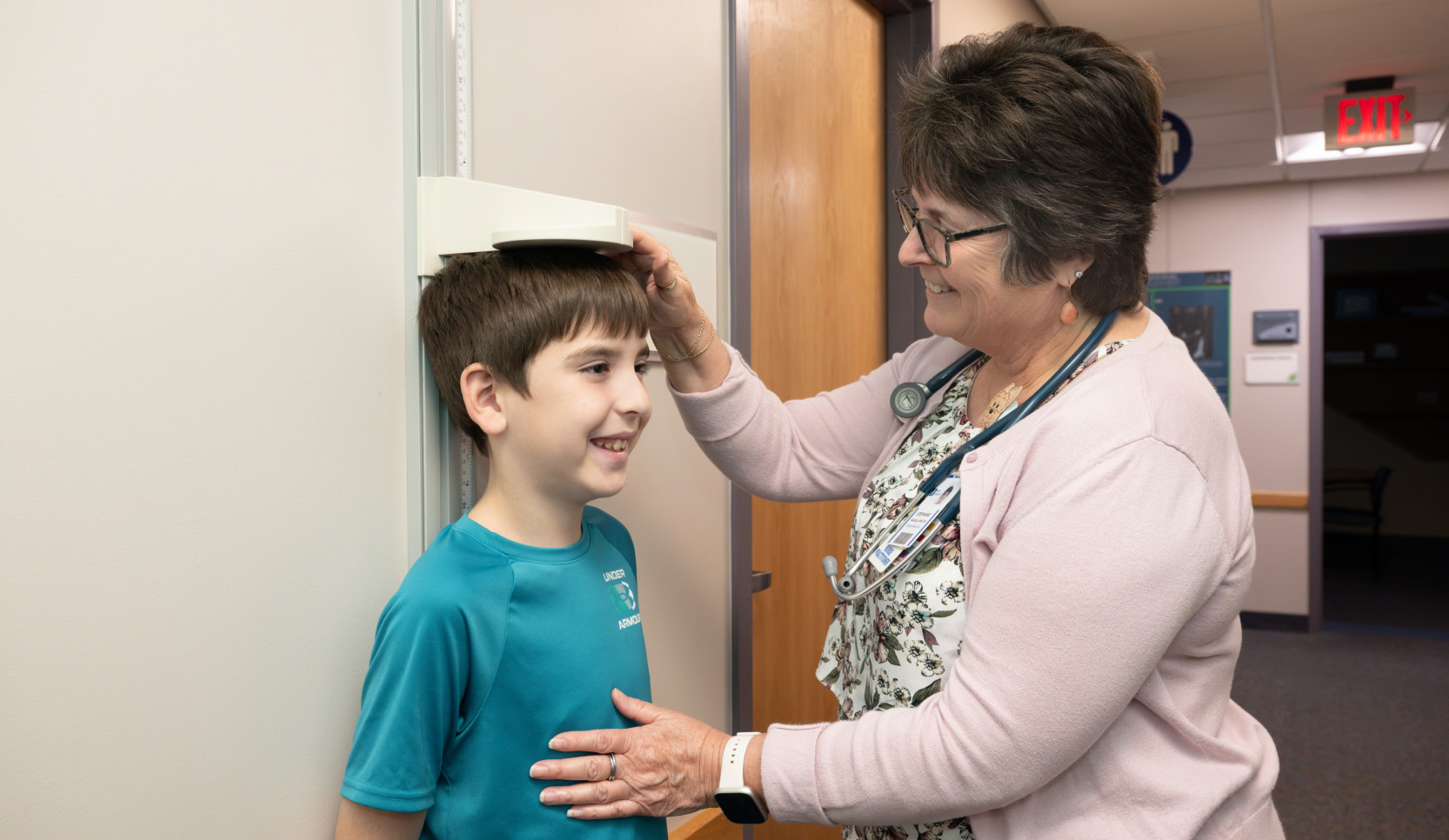 Image of a provider measuring a boy's height