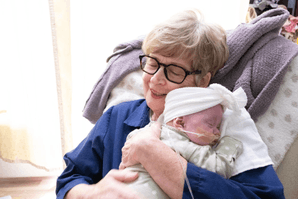 Volunteer holding a baby