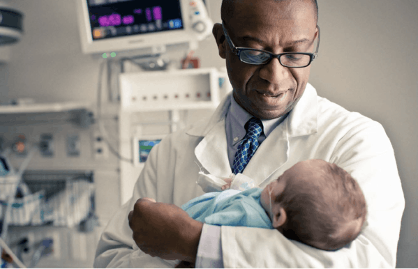 Dr. Forbes and baby - More Childhood Please Magazine