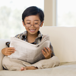 Ethnic boy with glasses and newspaper Featured Image for Ethnic boy with newspaper