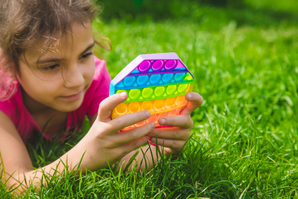 Featured Image for Young girl in grass with fidget toy