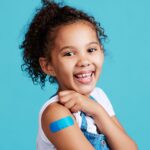 Shot of a little girl showing off a bandaid on her arm