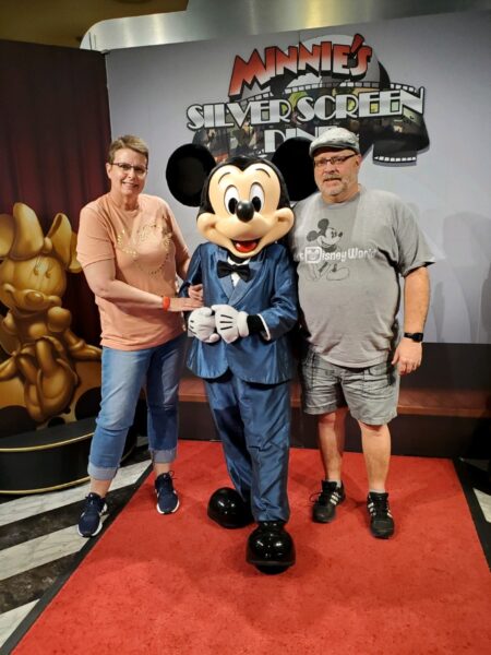 Connie Stout and her husband DeWayne are shown with Mickey Mouse