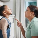 Shot of a little girl being spoken to sternly at home by her mother
