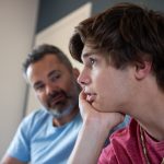 GettyImages - teen boy talking to dad