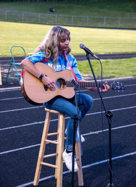 Melaina Uhrig plays guitar