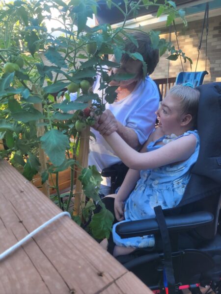 Marissa Anderegg and Lori Penrod work in container garden