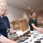 Brittany Cogdeill and Nancy Carst sort books
