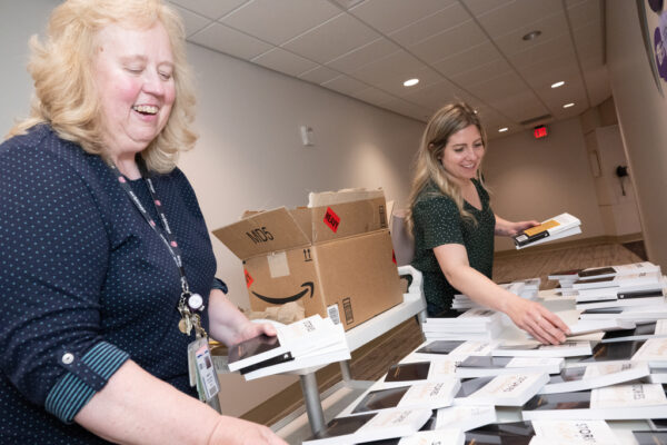 Brittany Cogdeill and Nancy Carst sort books 