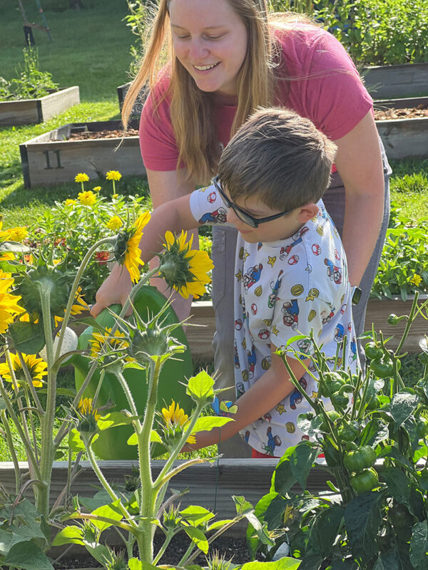 Occupational therapy patient watering flowers.