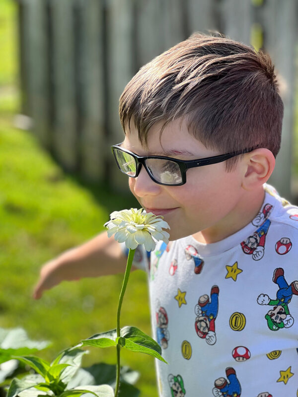 Asher learning to "stop and smell the roses."