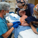 Dr. Matthew Mitchell administers spinal anesthesia.