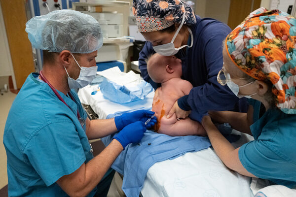 Dr. Matthew Mitchell administers spinal anesthesia.