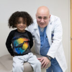 Dr. Reinaldo Garcia examines his patient Bryson Proctor