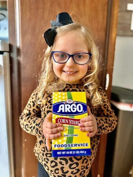 Quinn Williams holds cornstarch box, a mainstay in her diet