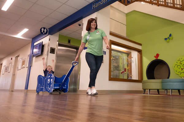 Suzy Dragus gives a patient a ride in one of the hospital's wagons.