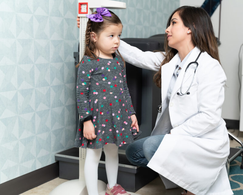Child getting measured at pediatrician's office