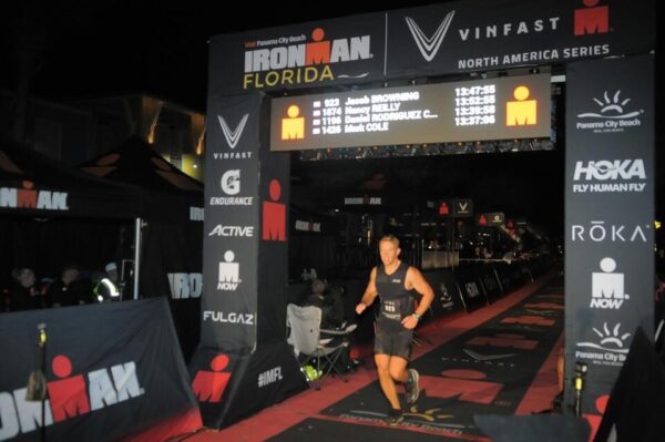 Jacob Browning crossing the Ironman finish line