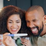 GettyImages - happy couple with pregnancy test