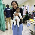 Mending hearts across borders: Dr. Karamlou’s first medical mission TK holding baby 1