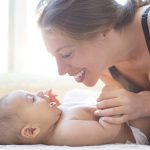 Infant massage for babies: Benefits for sleep, bonding and development Mother playing with baby boy