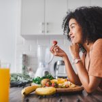 Shot of a young woman making a healthy snack with fruit at home