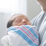 GettyImages-mom with newborn in blanket