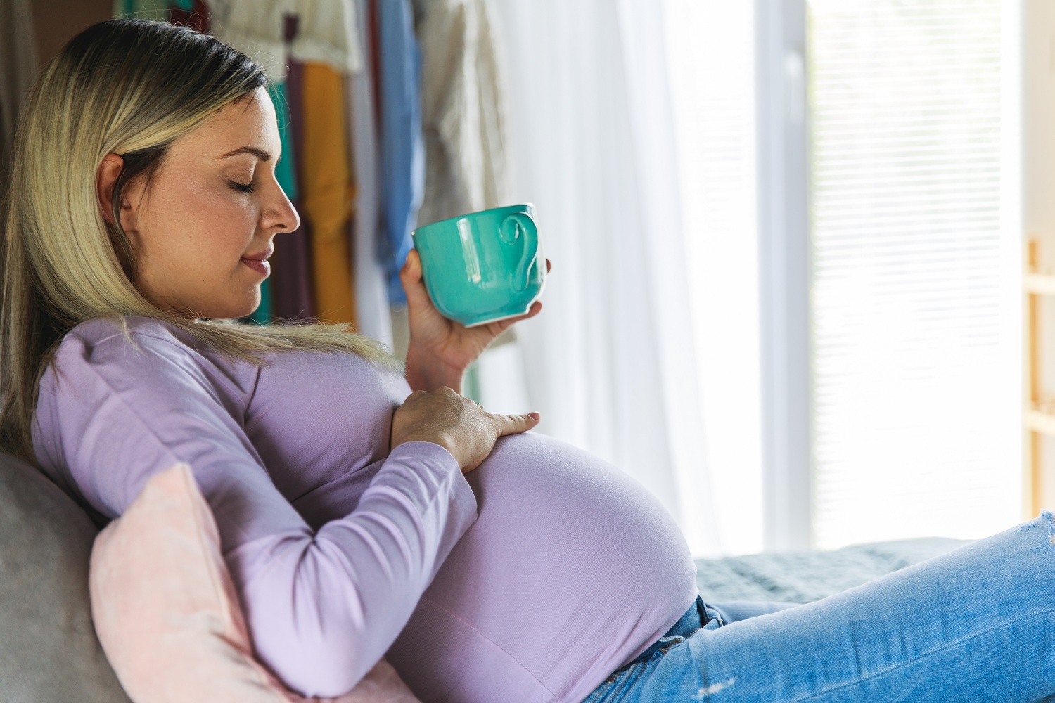 GettyImages- pregnant woman at home with coffee