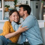 Young couple kiss on couch - resized for blog
