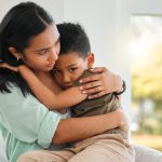 Mom comforting young son