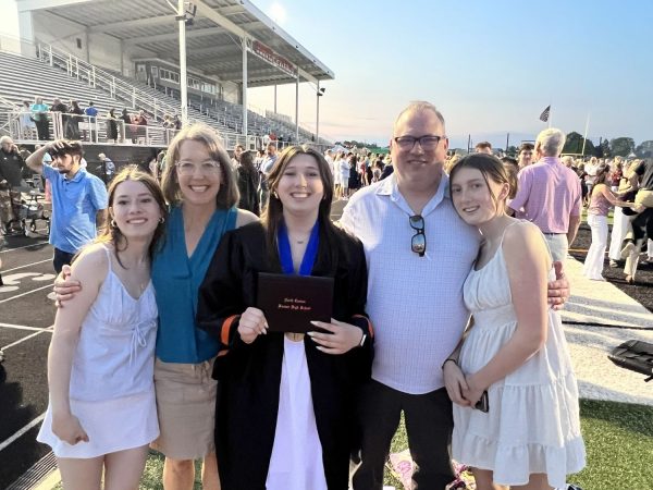 Patient Allison Dennison with her family at a relative's graduation in a football stadium.