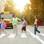Walking to school in the dark? Here’s how to stay safe Group of children crossing a crosswalk on their way to school